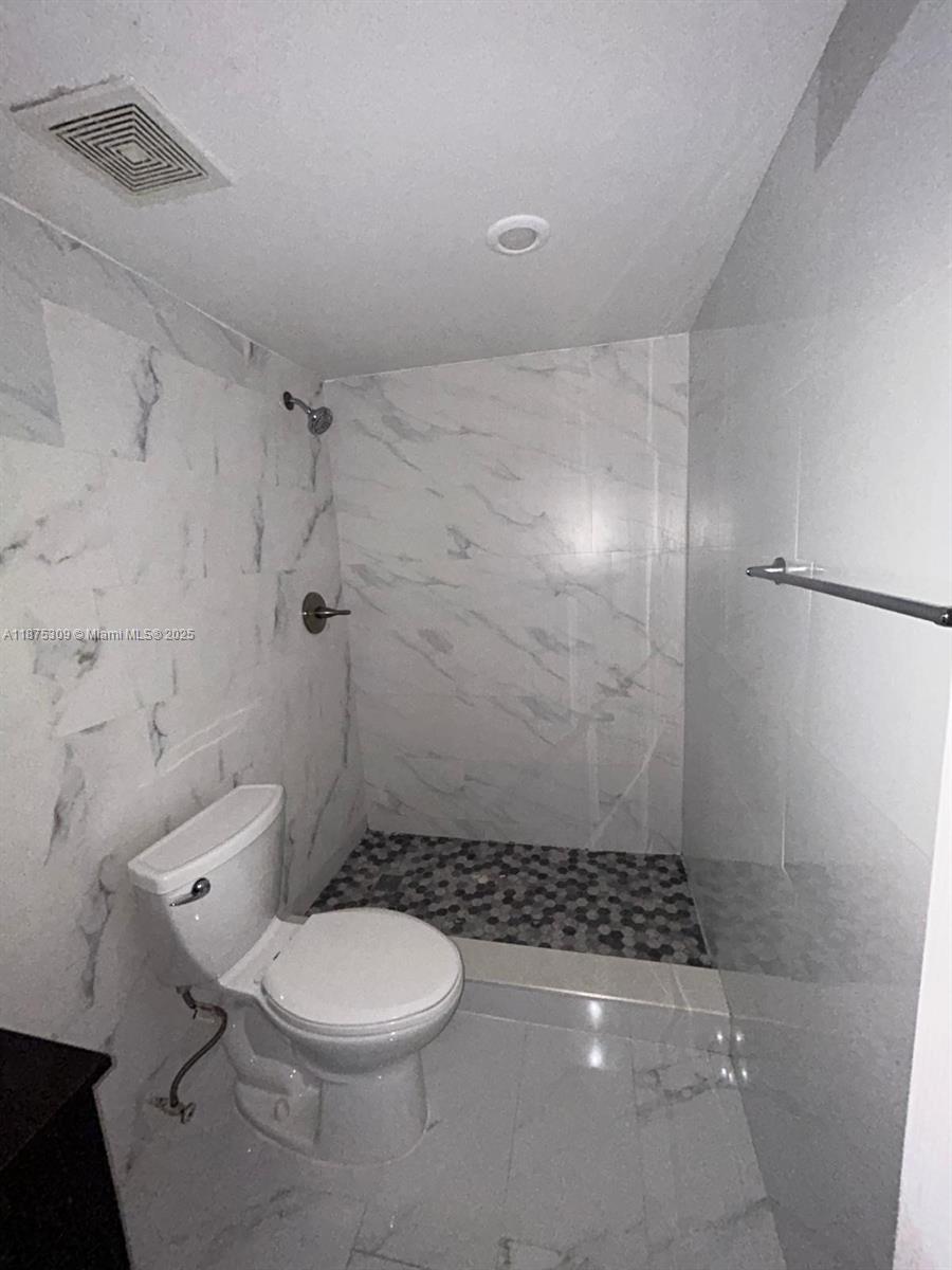 19741 Southwest 114th Avenue, Unit 361 Miami, FL 33157 - Photo 16 of 20 a bathroom with a toilet and a shower