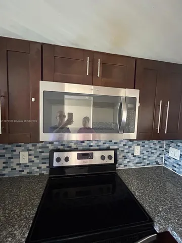 a stove top oven sitting inside of a kitchen