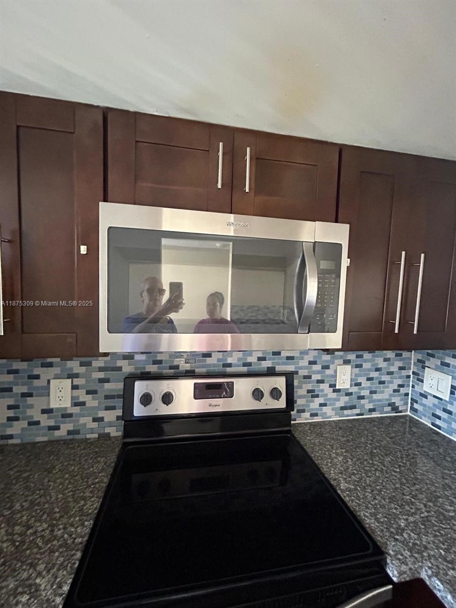 19741 Southwest 114th Avenue, Unit 361 Miami, FL 33157 - Photo 3 of 20 a stove top oven sitting inside of a kitchen