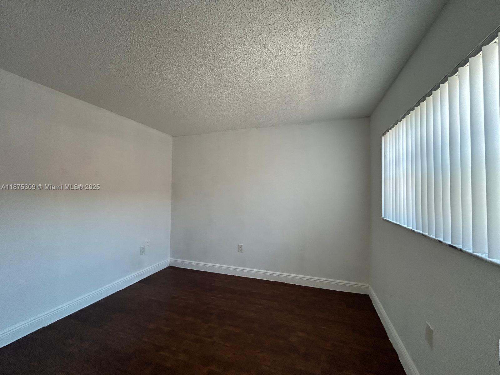 19741 Southwest 114th Avenue, Unit 361 Miami, FL 33157 - Photo 8 of 20 an empty room with wooden floor and windows