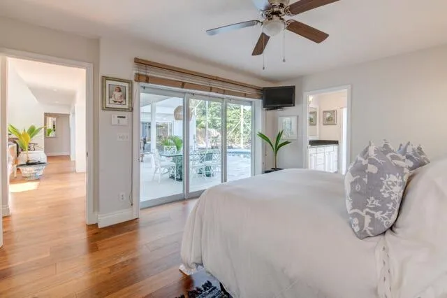 a bedroom with a large bed and a chandelier