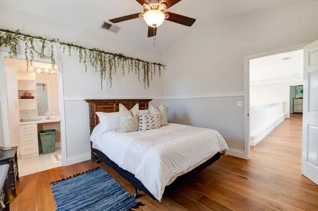 a bedroom with a bed and wooden floor