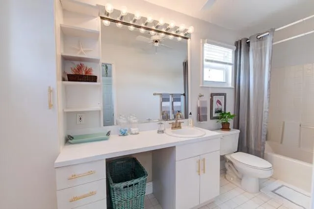 a bathroom with a sink a toilet a mirror and shower