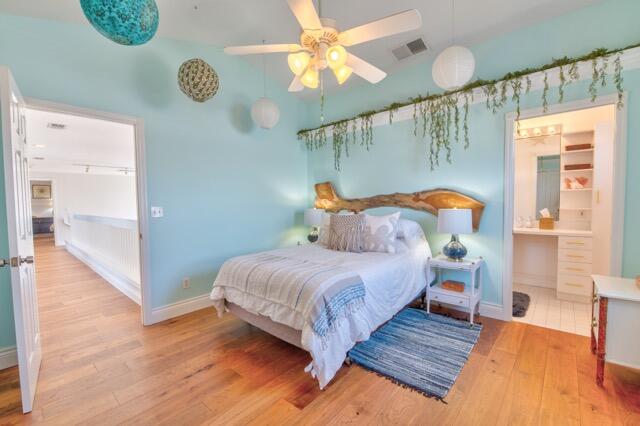 5125 Southeast Matousek Street Stuart, FL 34997 - Photo 21 of 39 a bedroom with a bed and a chandelier