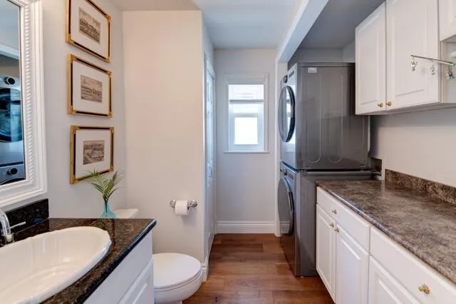 a spacious bathroom with a granite countertop toilet sink and mirror