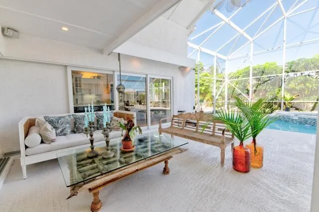 a living room with furniture gym equipment and a potted plant