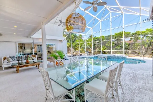 a dining room with furniture and a large window
