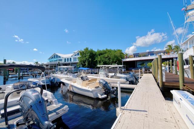 5125 Southeast Matousek Street Stuart, FL 34997 - Photo 38 of 39 a view of a patio with couches and dining table with chairs