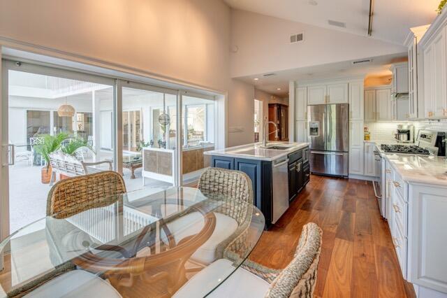5125 Southeast Matousek Street Stuart, FL 34997 - Photo 8 of 39 a living room with furniture wooden floor and a fireplace