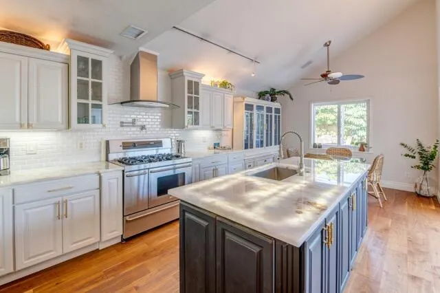 a kitchen with a stove sink and cabinets