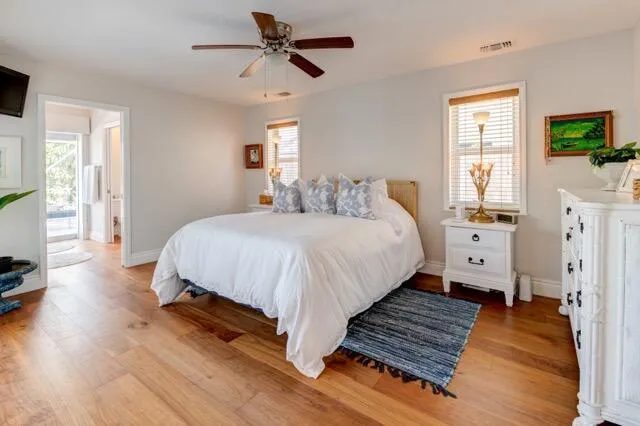 a bedroom with bed and a flat tv screen on dresser