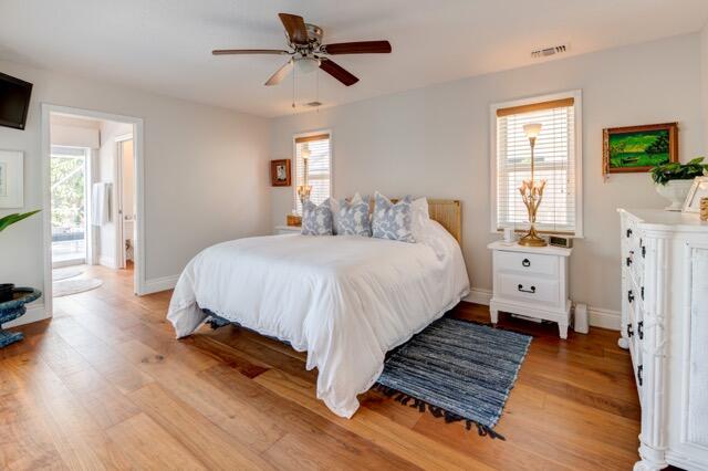 5125 Southeast Matousek Street Stuart, FL 34997 - Photo 10 of 39 a bedroom with bed and a flat tv screen on dresser