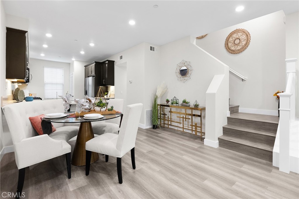 67 Plateau Irvine, CA 92618 - Photo 11 of 32 a dining room with furniture a chandelier and wooden floor