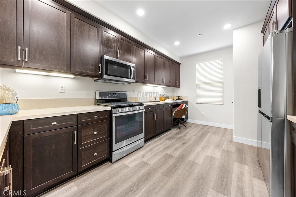 67 Plateau Irvine, CA 92618 - Photo 13 of 32 a kitchen with stainless steel appliances granite countertop a refrigerator and a stove top oven