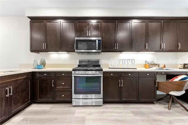 a kitchen with stainless steel appliances granite countertop a stove and cabinets