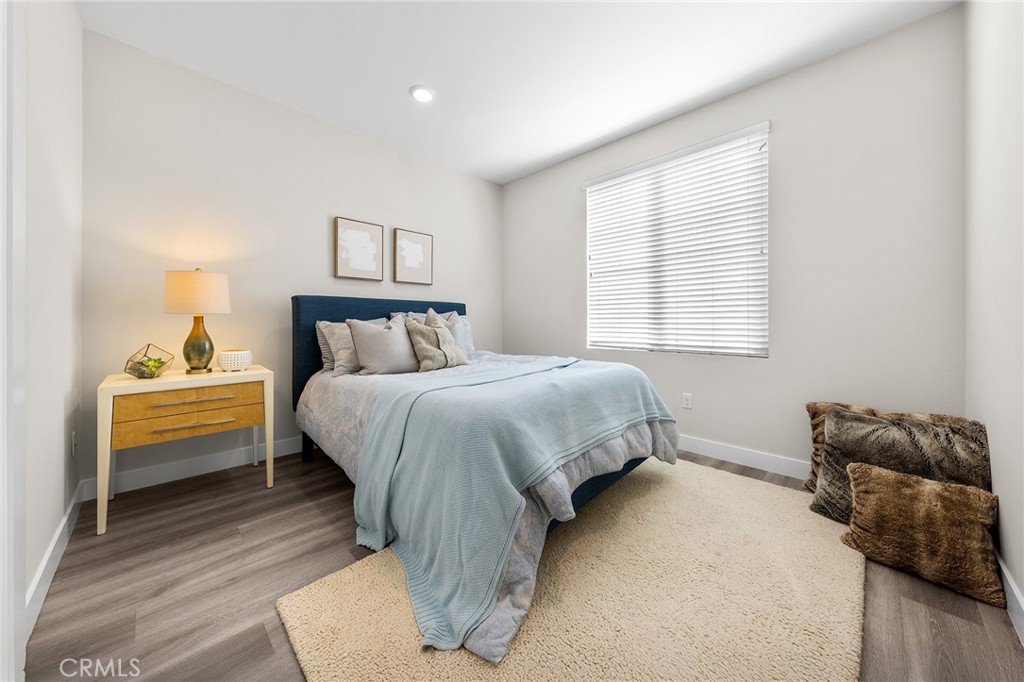 67 Plateau Irvine, CA 92618 - Photo 19 of 32 a bedroom with a bed and wooden floor