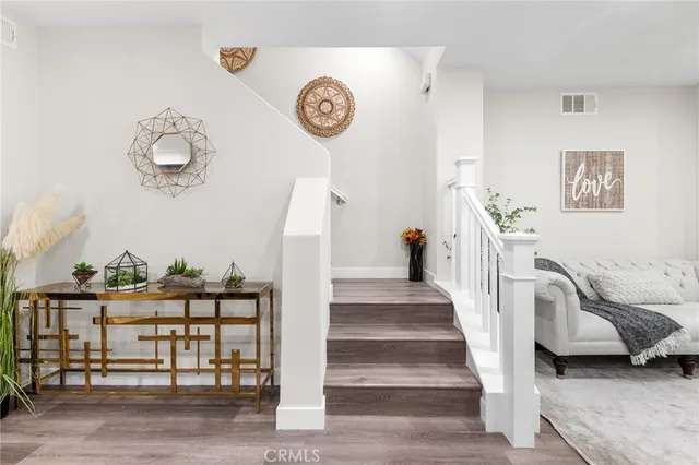 a view of a livingroom with furniture and a fan