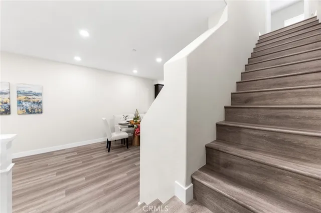 a view of entryway and hall with wooden floor