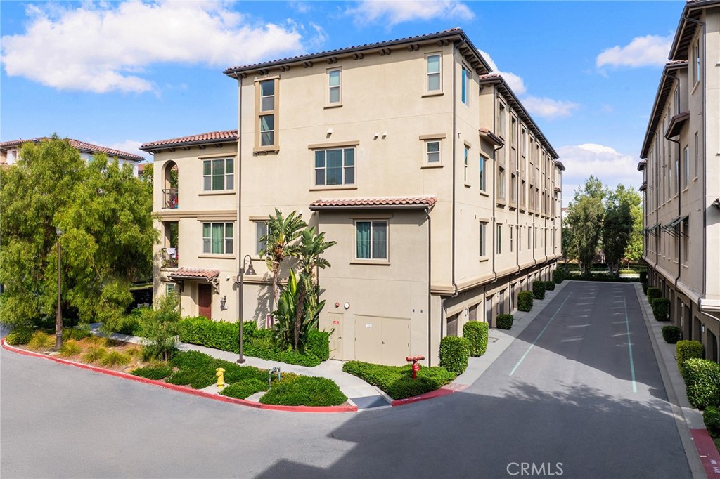 67 Plateau Irvine, CA 92618 - Photo 28 of 32 a view of a white house with many windows and plants