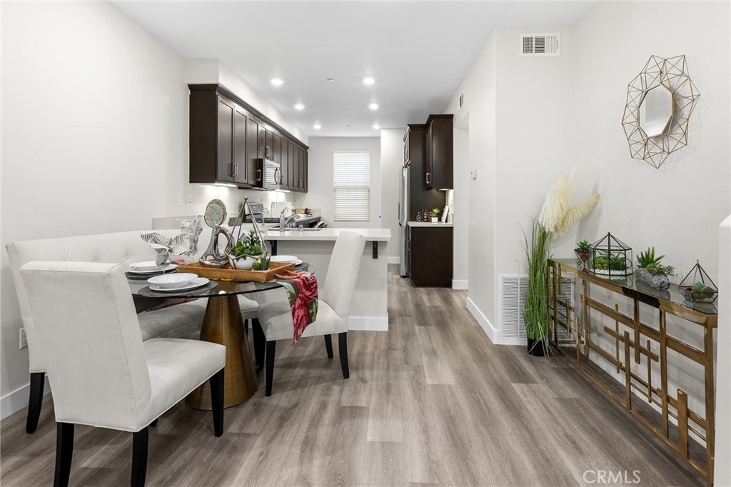 67 Plateau Irvine, CA 92618 - Photo 10 of 32 a view of a dining room with furniture window and wooden floor
