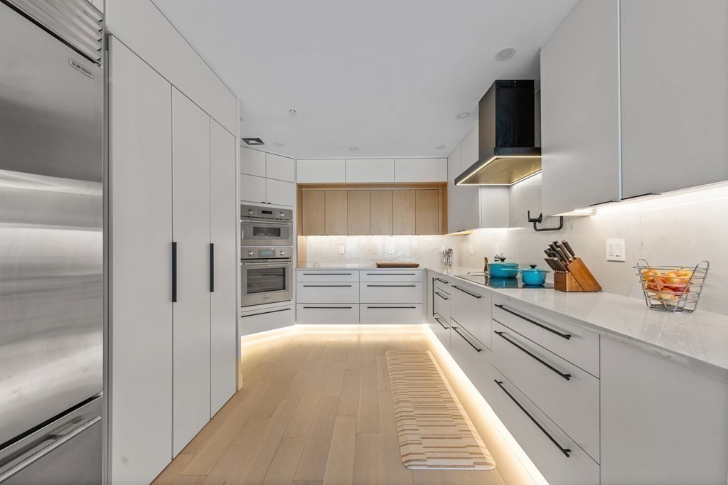 197 8th Street, Unit PH12 Boston, MA 02129 - Photo 12 of 42 a kitchen with stainless steel appliances a refrigerator sink and cabinets