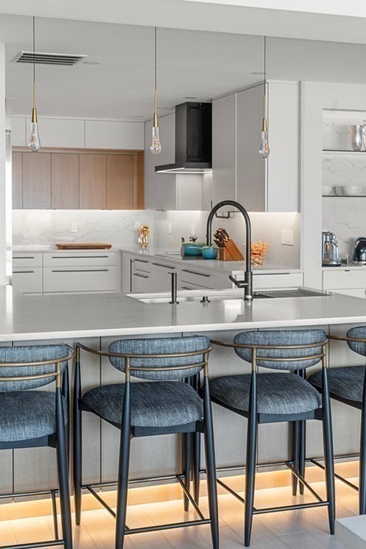 197 8th Street, Unit PH12 Boston, MA 02129 - Photo 14 of 42 a kitchen with a table chairs and a refrigerator