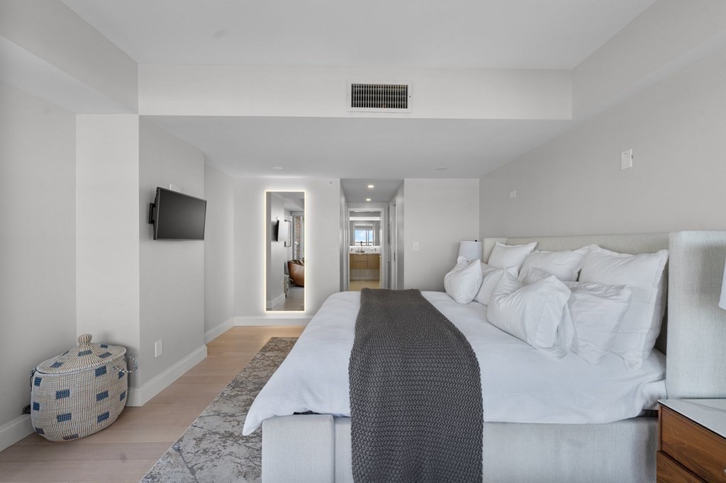 197 8th Street, Unit PH12 Boston, MA 02129 - Photo 25 of 42 a bedroom with a large bed and a flat screen tv