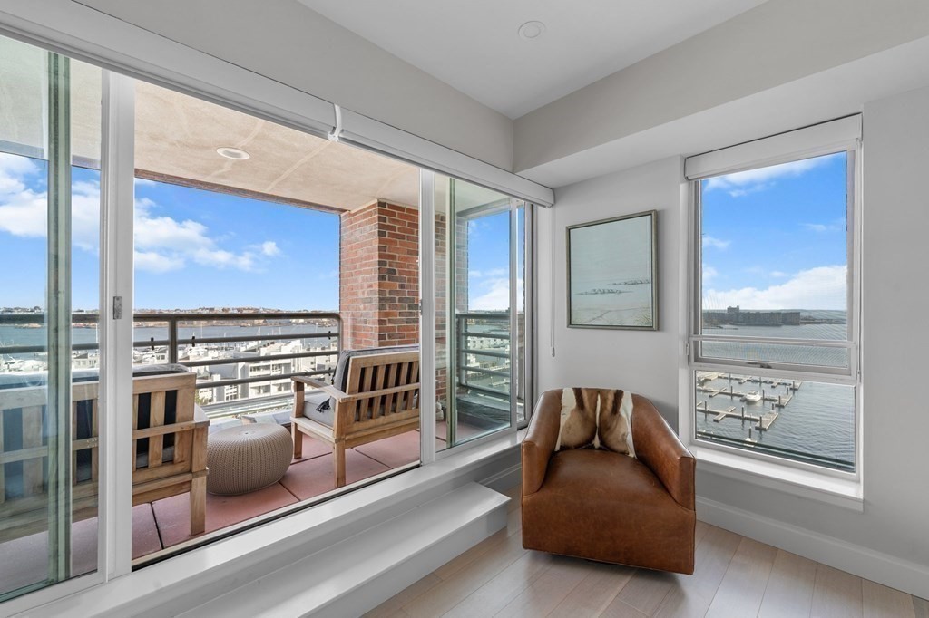 197 8th Street, Unit PH12 Boston, MA 02129 - Photo 31 of 42 a living room with furniture and a floor to ceiling window