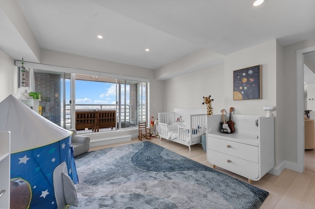197 8th Street, Unit PH12 Boston, MA 02129 - Photo 33 of 42 a living room with furniture and a flat screen tv
