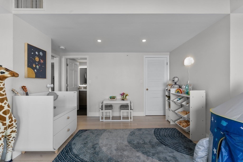 197 8th Street, Unit PH12 Boston, MA 02129 - Photo 34 of 42 a living room with furniture and a wooden floor