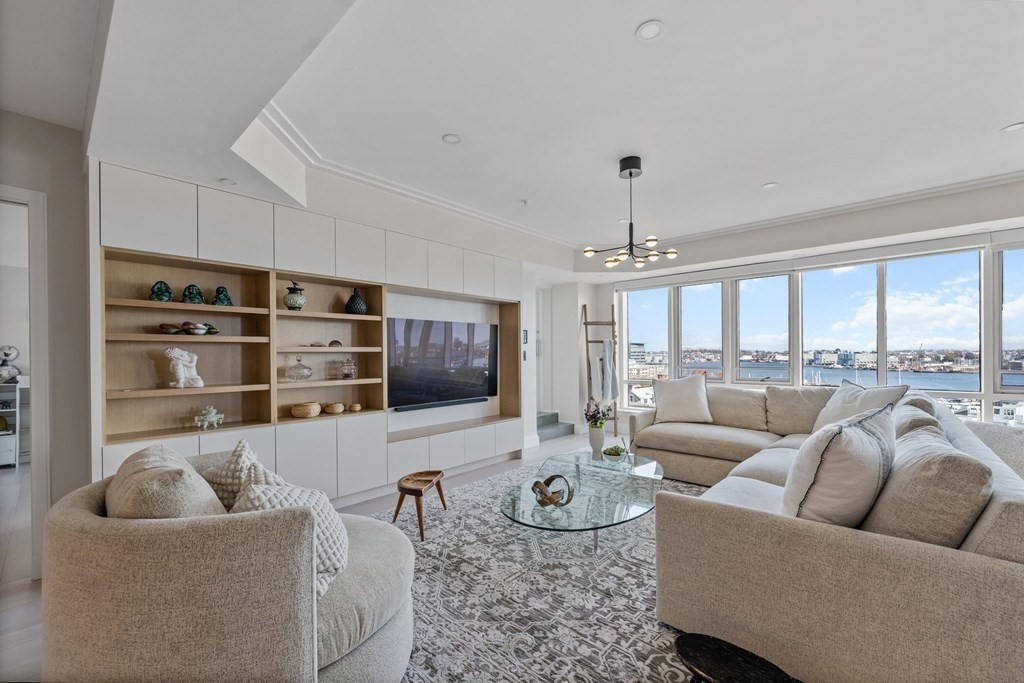 197 8th Street, Unit PH12 Boston, MA 02129 - Photo 5 of 42 a living room with furniture and a flat screen tv