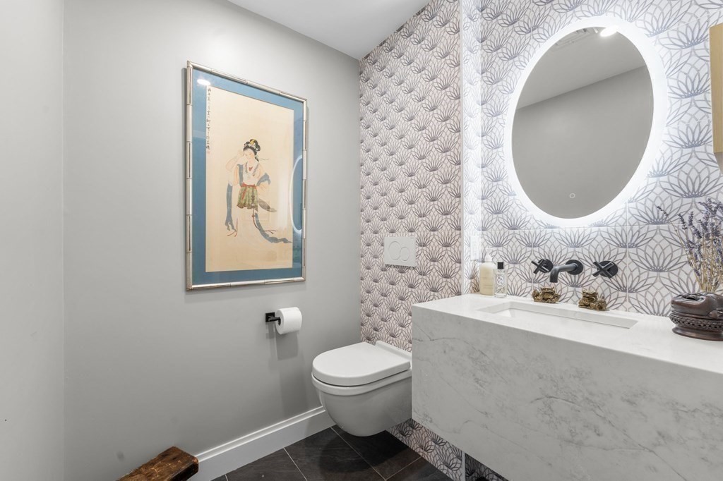 197 8th Street, Unit PH12 Boston, MA 02129 - Photo 9 of 42 a bathroom with a toilet sink and mirror