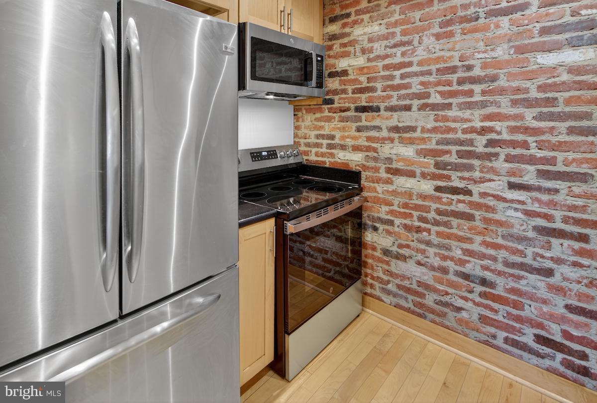 1810 California Street Northwest, Unit 202 Washington, DC 20009 - Photo 12 of 52 Chic kitchen with exposed brick charm.
