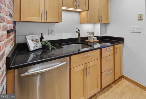 a kitchen with stainless steel appliances granite countertop a sink and cabinets