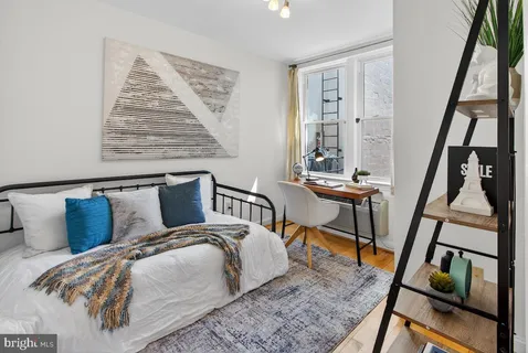 a bedroom with furniture and a window
