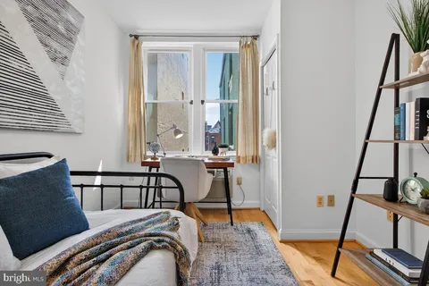 a bed sitting in a bedroom next to a window