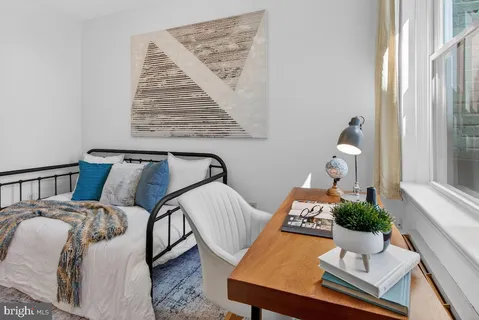 a view of a bedroom with bed and wooden floor