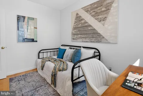 a view of a bedroom with furniture and wooden floor