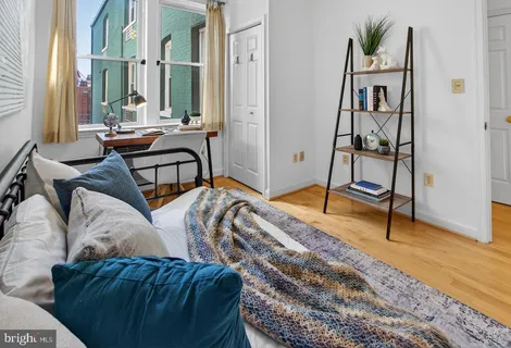 a bedroom with furniture and a wooden floor