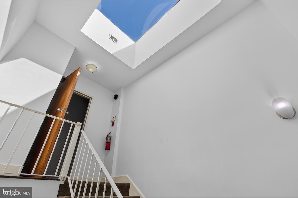 1810 California Street Northwest, Unit 202 Washington, DC 20009 - Photo 42 of 52 Bright stairway with skylight view.