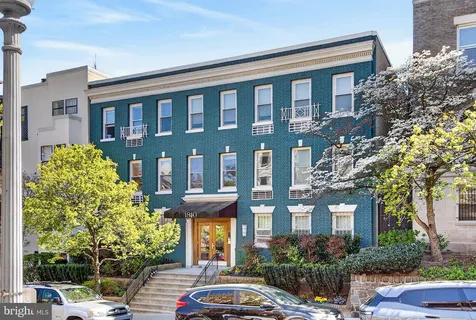 a couple of cars parked in front of a building
