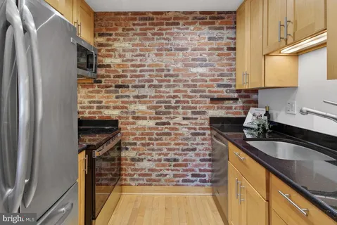 a kitchen with a sink and a refrigerator