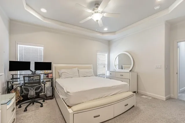 a bedroom with a bed and a desk