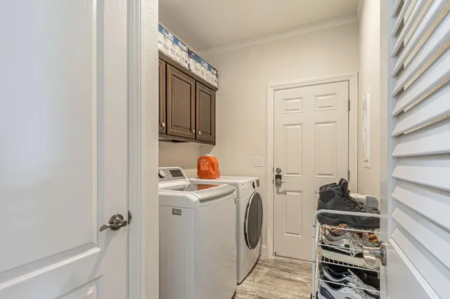 a view of a storage and utility room with washer and dryer