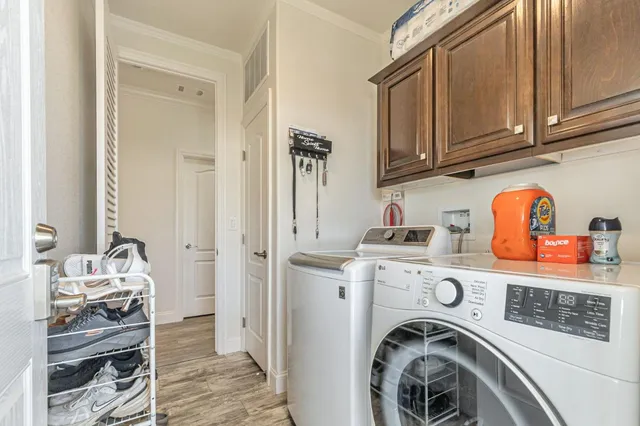 a utility room with sink dryer and washer
