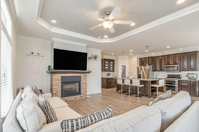 a living room with furniture fireplace and a flat screen tv