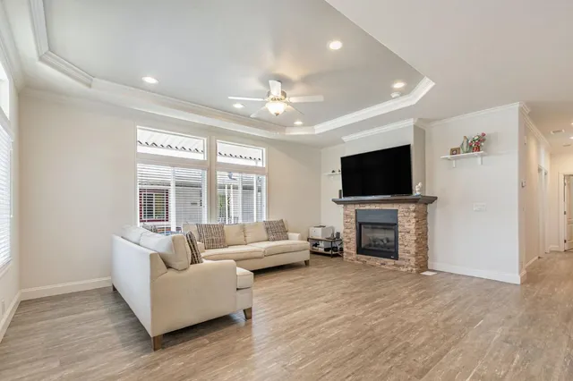 a living room with fireplace furniture and a flat screen tv