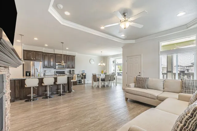 a living room kitchen with furniture and wooden floor