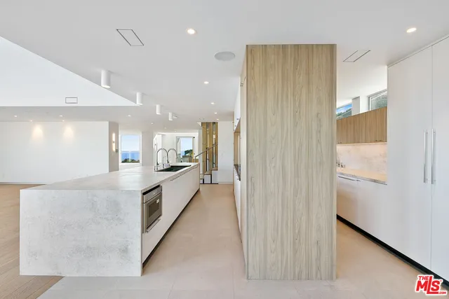 a view of a hallway with wooden floor and entryway