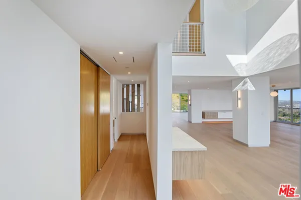 a bedroom with a bed and glass windows